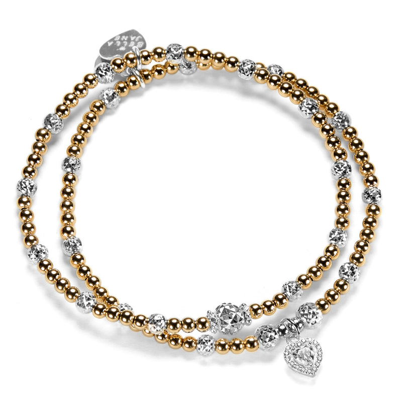 2 gold-filled beaded Bella Jane stacking bracelets, featuring sparkly sterling silver faceted beads, with one bracelet featuring a sterling silver and cubic zirconia sparkly heart charm, against a white background.