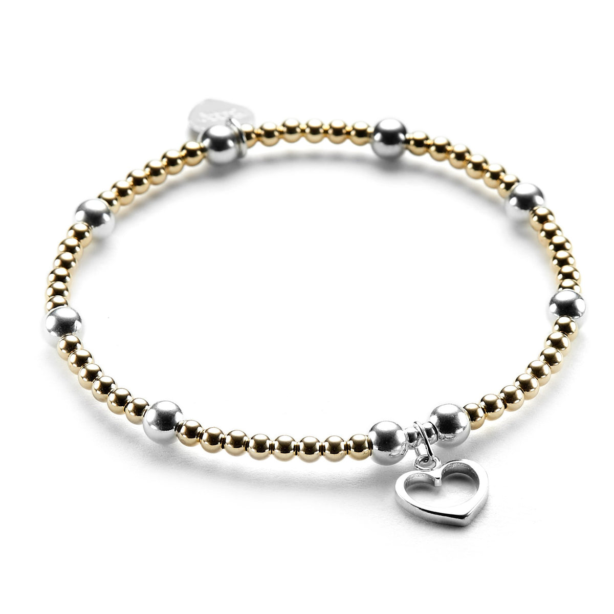 Gold-fiilled and sterling silver beaded bracelet featuring a silver open heart charm on a white background