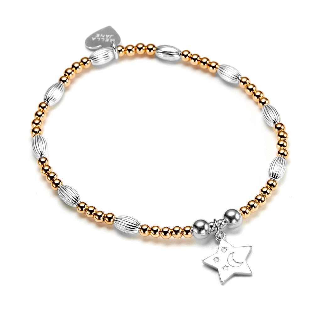 Bracelet with gold and silver beads and a star charm on a white background