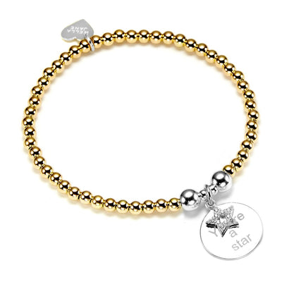 Gold beaded bracelet with a silver disc charm and sparkly silver star, with the words 'You're a star' engraved, on a white background