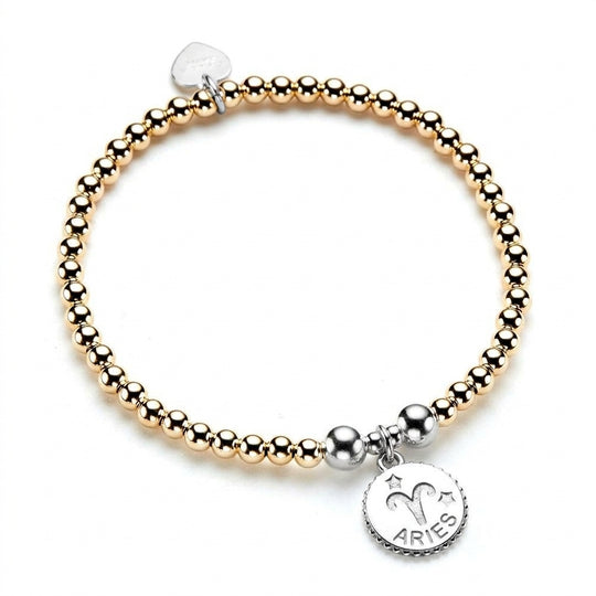 Gold-filled and sterling silver beaded bracelet with a sterling silver Aries zodiac disc charm, on a white background