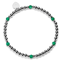 Sterling silver beaded bracelet with green beads and on a white background