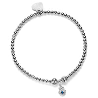 Sterling silver beaded stacking bracelet with a cubic zirconia Hamsa Hand charm, on a white background