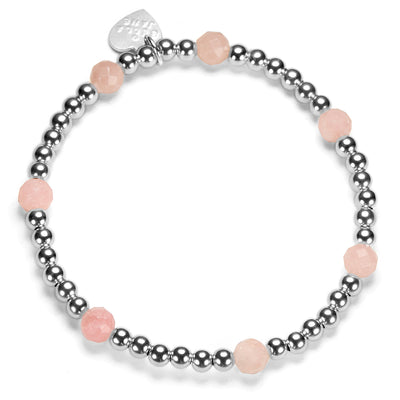 Beaded stacking bracelet with sterling silver and pink opal beads, with Bella Jane branded silver heart tag, on a white background.