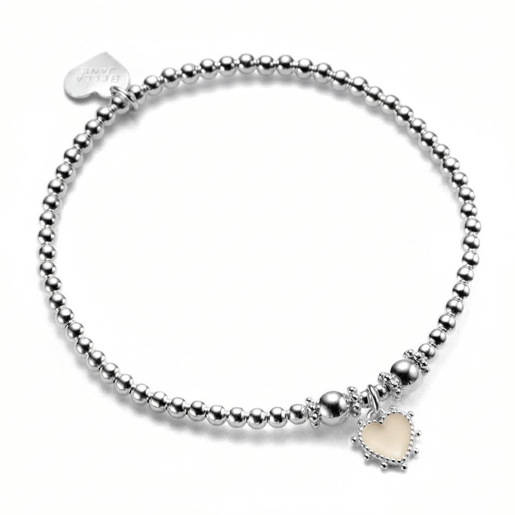 A sterling silver beaded bracelet, featuring a sterling silver and ivory coloured enamel heart charm, with little silver bobbles around the edge of the heart. The photo is against a white background.