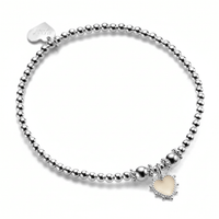 A sterling silver beaded bracelet, featuring a sterling silver and ivory coloured enamel heart charm, with little silver bobbles around the edge of the heart. The photo is against a white background.