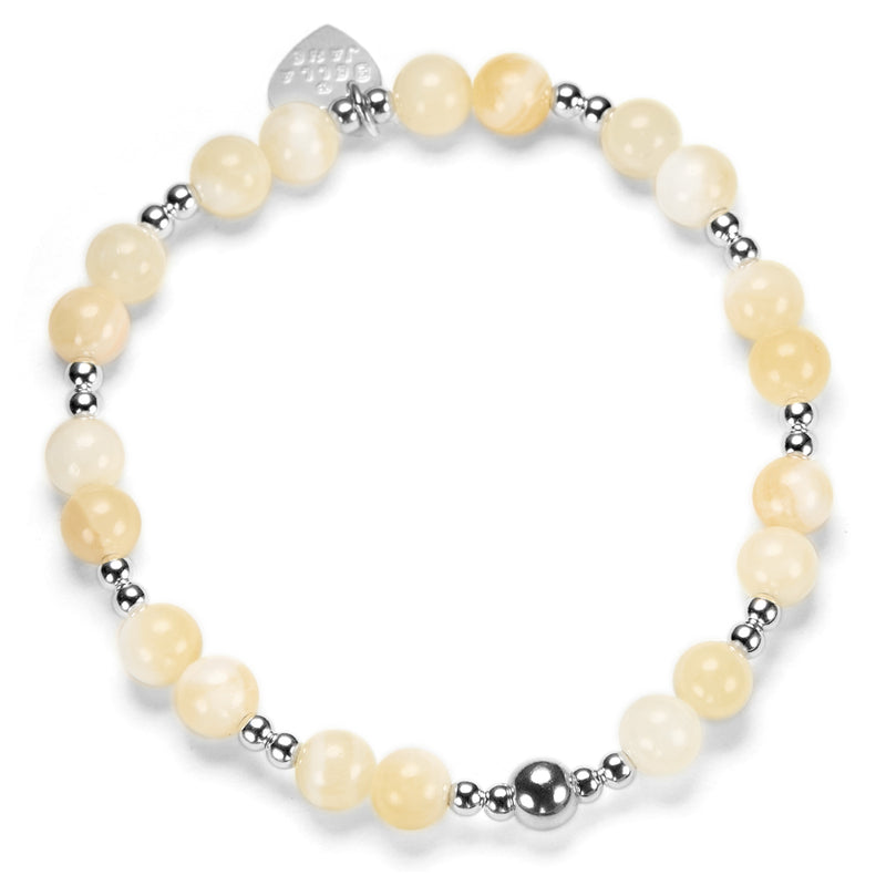 Bracelet with yellow beads and silver accents on a white background