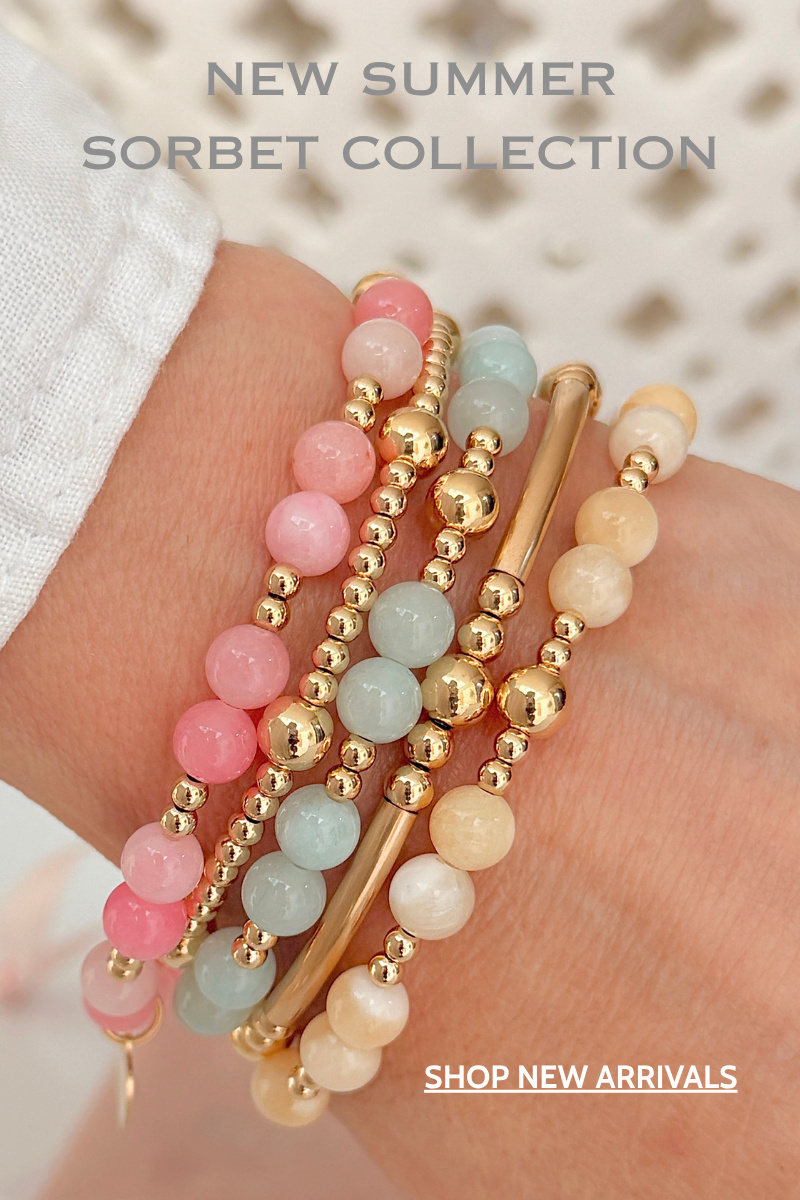 Stack of pastel coloured beaded stacking bracelets on a hand with 'New Summer Sorbet Collection' text.