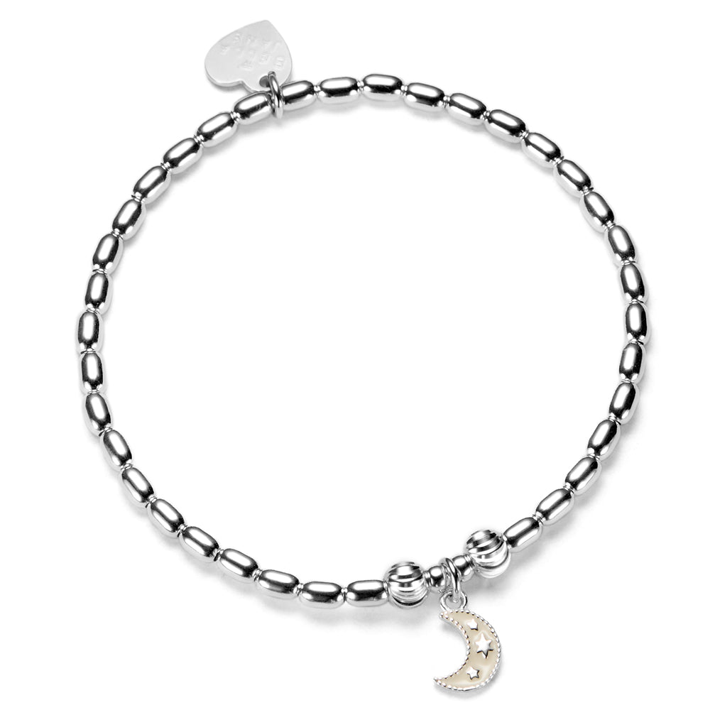 Silver bracelet with an ivory enamel moon char with 3 tiny stars, on a white background