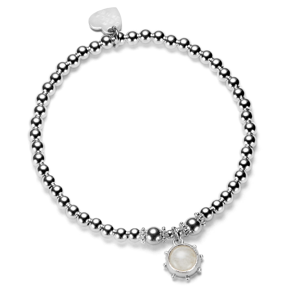 Silver beaded bracelet with a moonstone charm on a white background