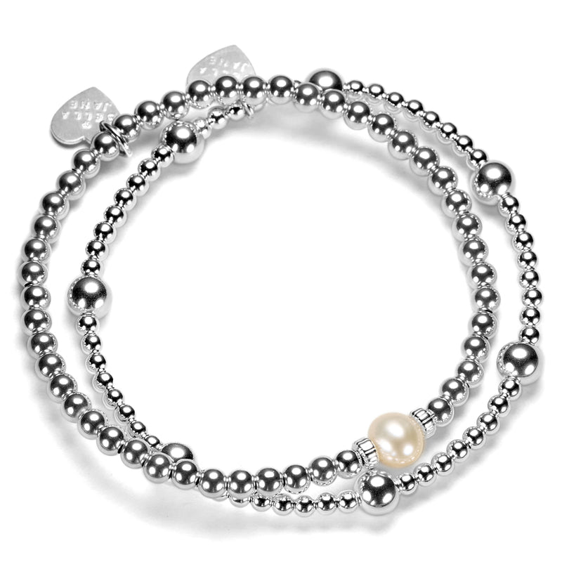 2 Silver beaded bracelets, one with a focal pearl, against a white background