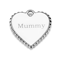 A close up of the engraved size of a heart charm on a white background