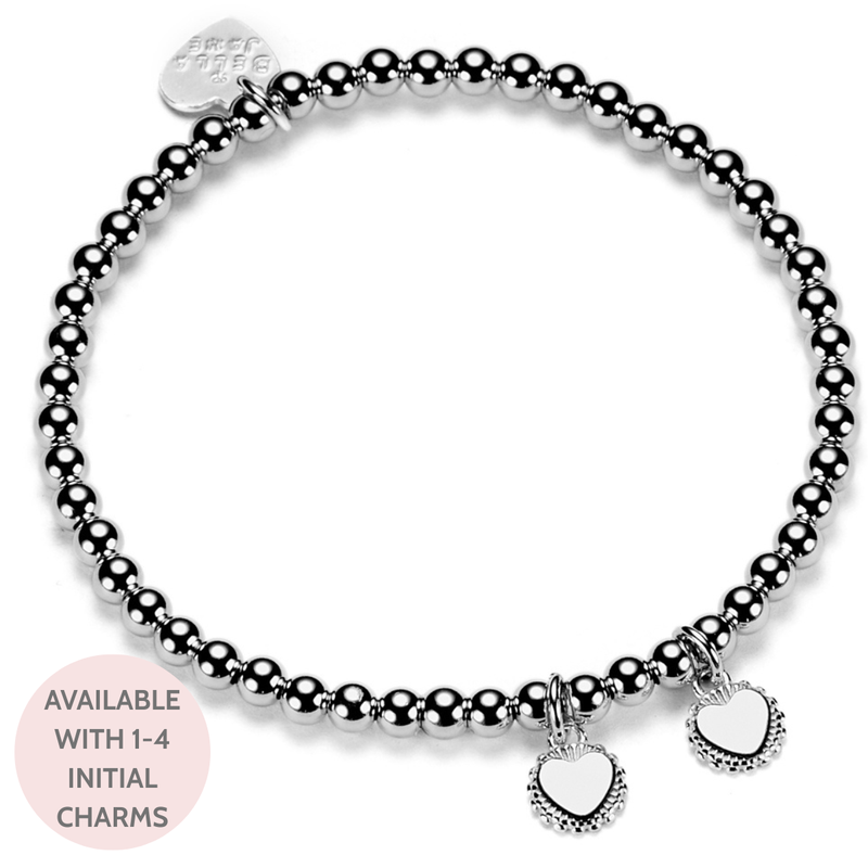 Silver beaded bracelet with heart-shaped charms on a white background