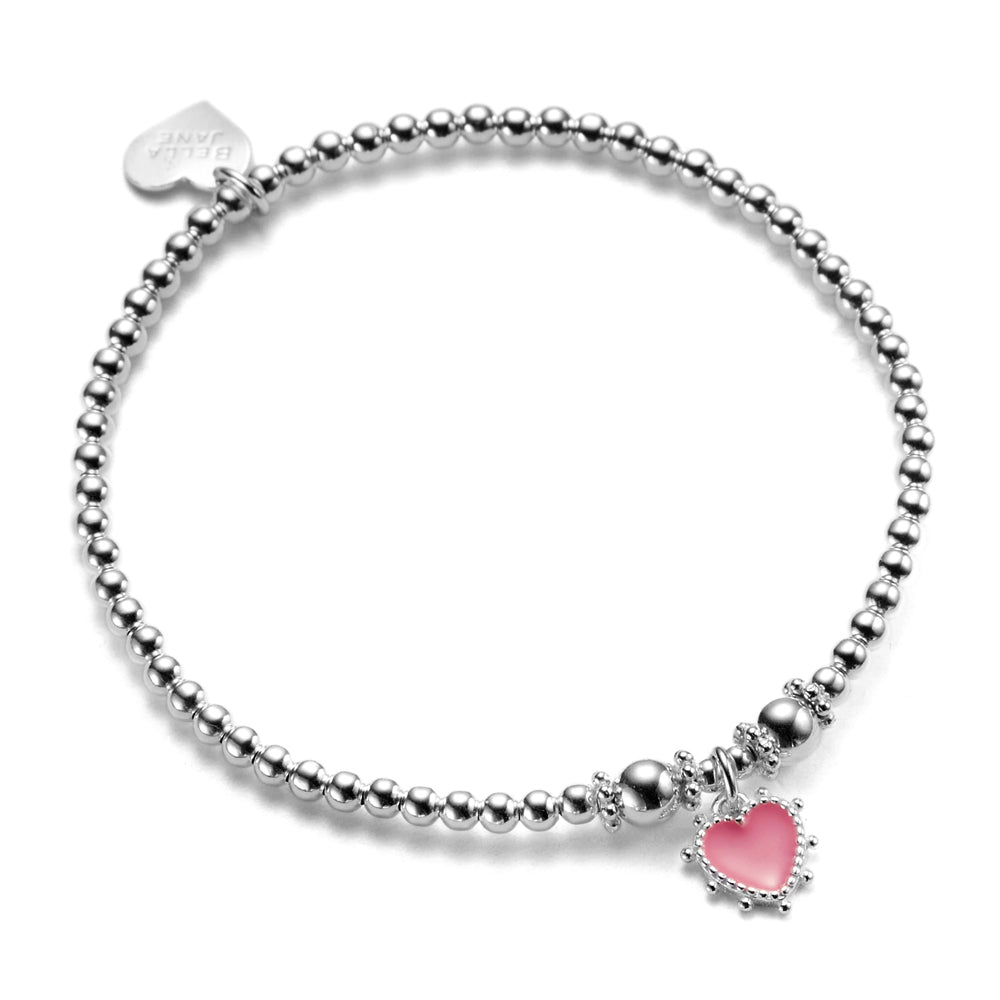A sterling silver bracelet with pink enamel heart charm and small heart tag, on a white background.