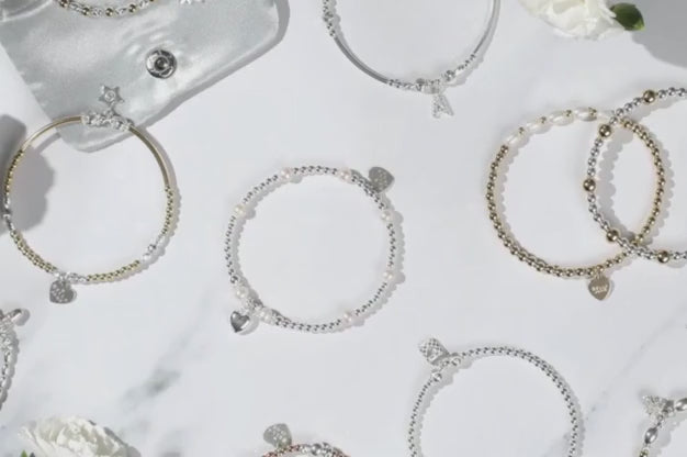 A range of sterling silver and gold beaded bracelets being gift wrapped.