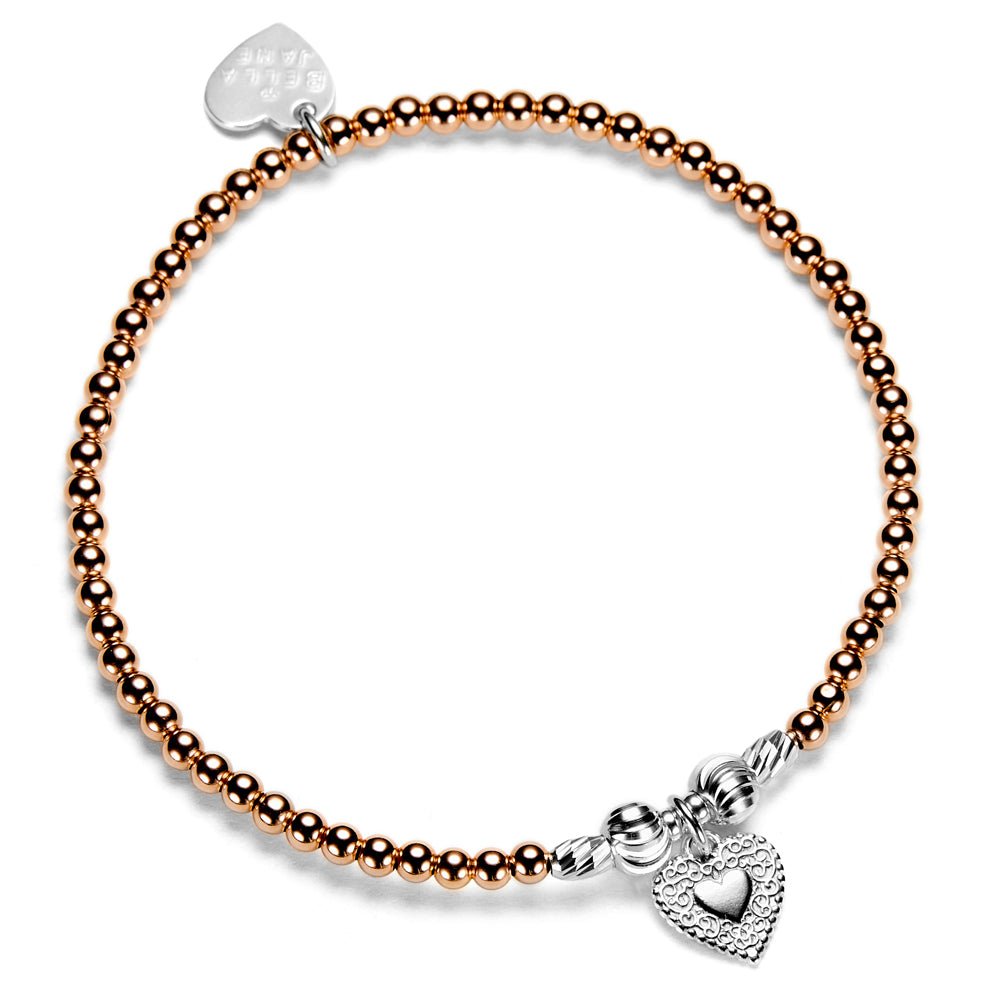 Rose gold beaded bracelet with silver heart charm on a white background