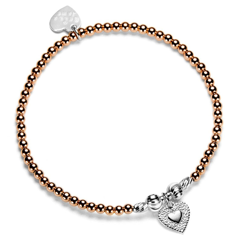 Rose gold beaded bracelet with silver heart charm on a white background