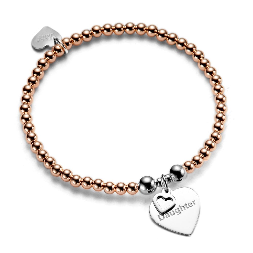 A bracelet with rose gold beads and a silver heart-shaped charm with the word 'Daughter' engraved on it.