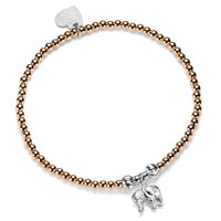 Bracelet with rose gold beads and silver elephant charm on a white background