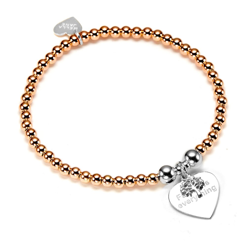 Rose gold beaded bracelet with a silver heart-shaped tag and family tree on a white background