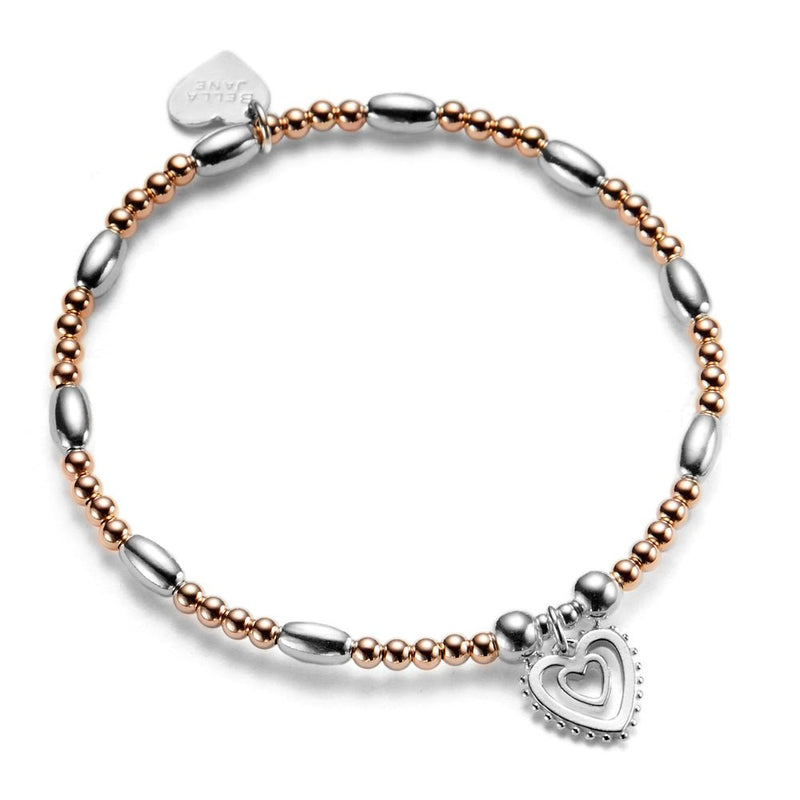 Rose gold ands silver beaded bracelet with silver heart-shaped charm on a white background