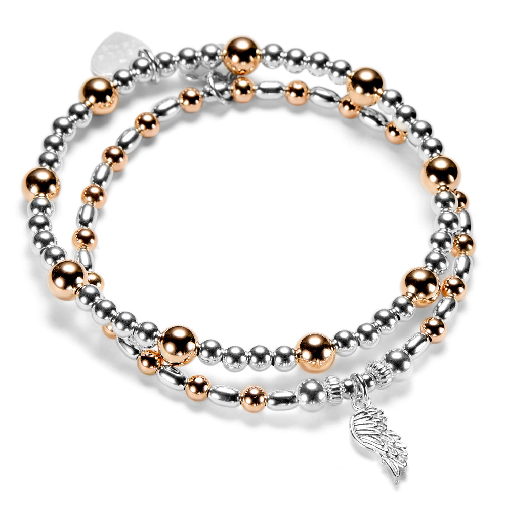 Silver and rose gold mixed metal beaded bracelet duo with a silver angel wing charm on a white background