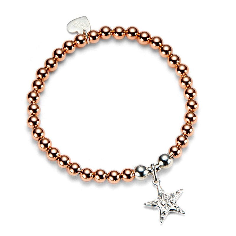 Rose gold beaded bracelet with a silver star charm on a white background