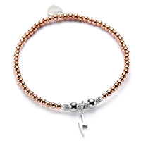 A rose gold stacking bracelet with a sterling silver lightning charm.