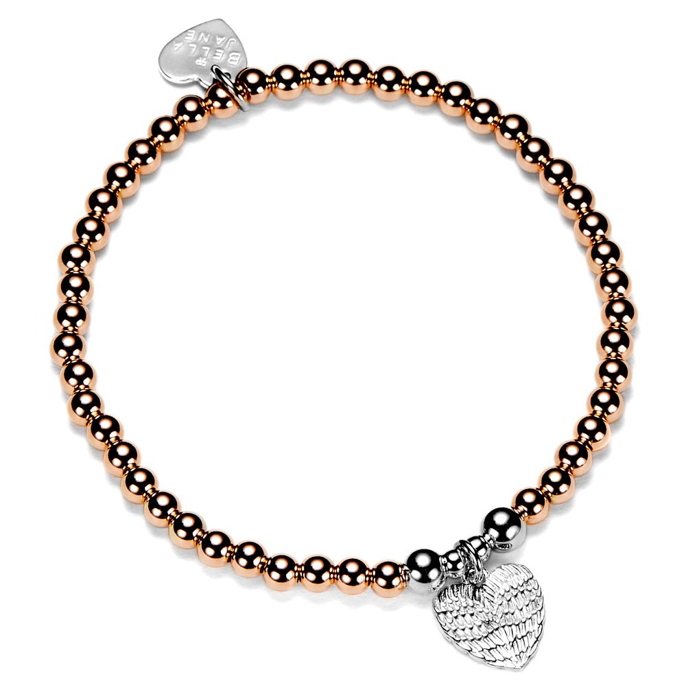 Rose gold and silver beaded bracelet with silver a silver heart angel wings charm, on a white background