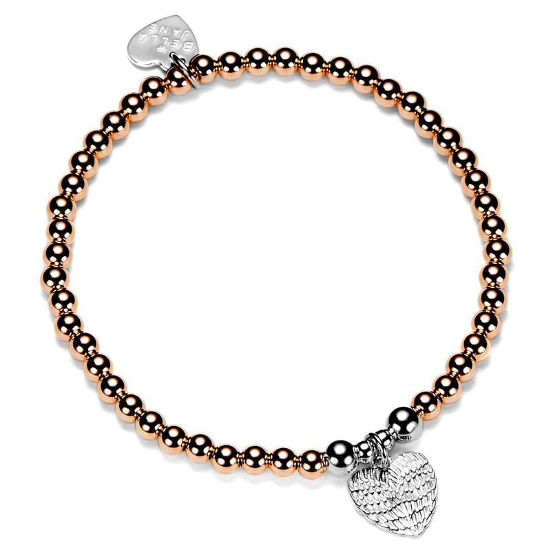 Rose gold and silver beaded bracelet with silver a silver heart angel wings charm, on a white background