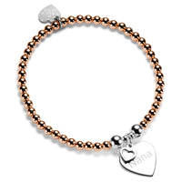 Rose gold beaded bracelet with silver heart-shaped charm featuring the word 'Nana' on a white background