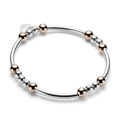 Sterling silver and rose gold beaded bracelet with noodle shaped and round beads on a white background