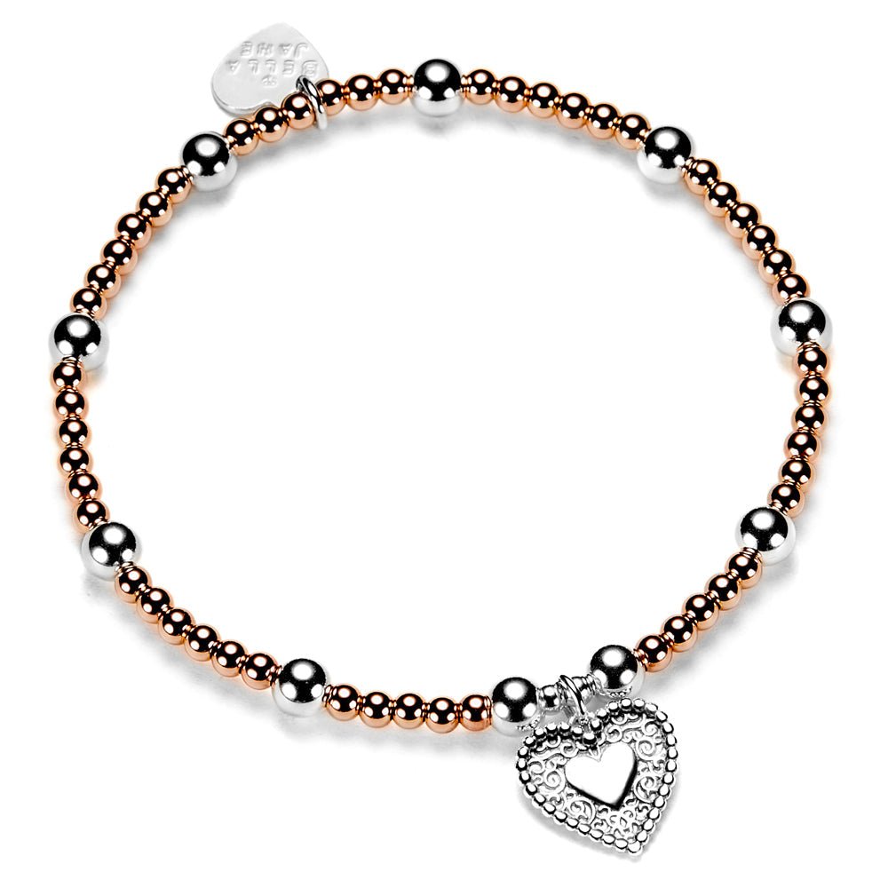 Bracelet with rose gold and silver beads and a heart-shaped charm on a white background