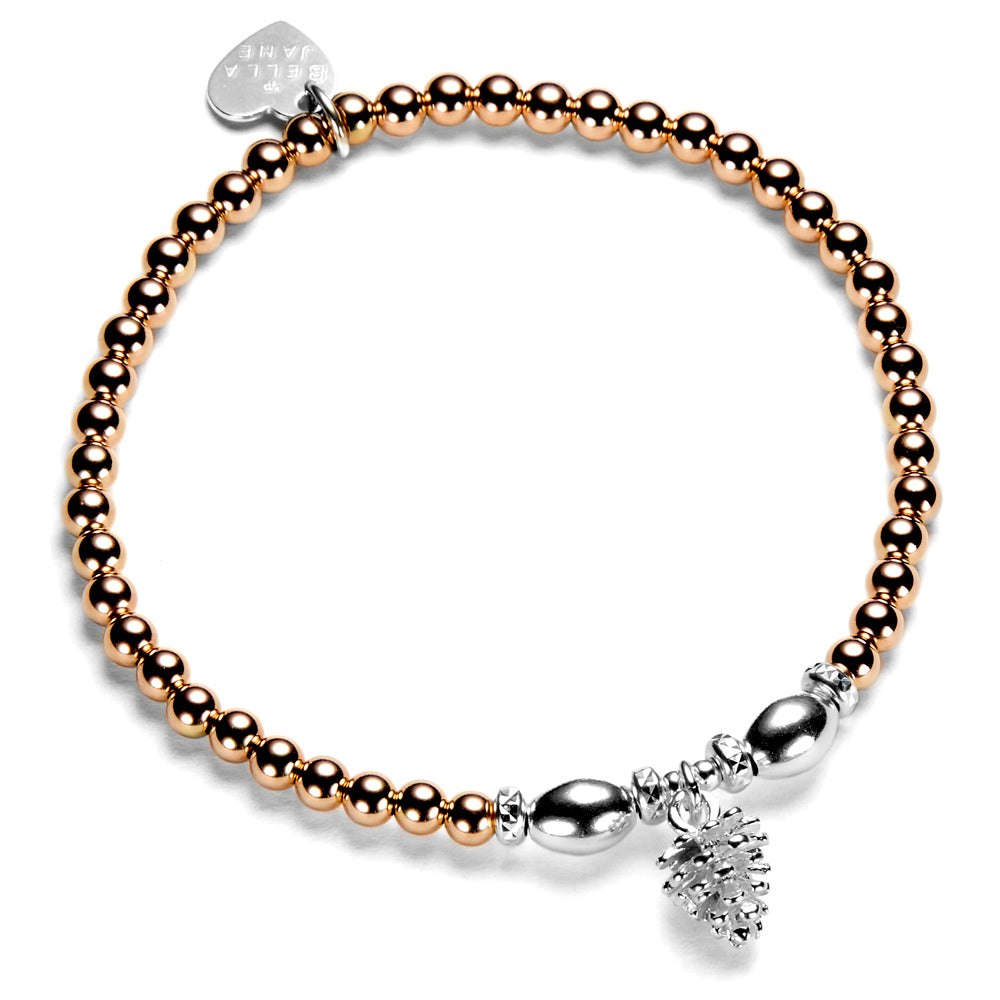 A rose gold-filled and sterling silver bracelet featuring a series of round and oval beads, a silver pine cone charm, and a heart-shaped tag, against a white background.