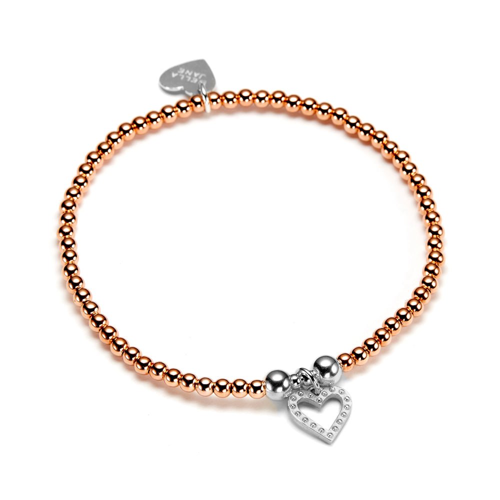 Rose gold beaded bracelet with studded silver heart charm on a white background