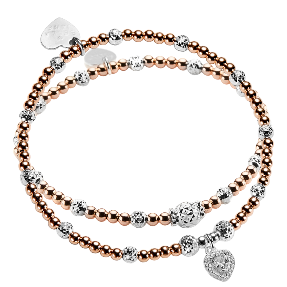 Two rose gold and silver mixed metal beaded stacking bracelets, one with a sparkly heart-shaped charm on a white background.