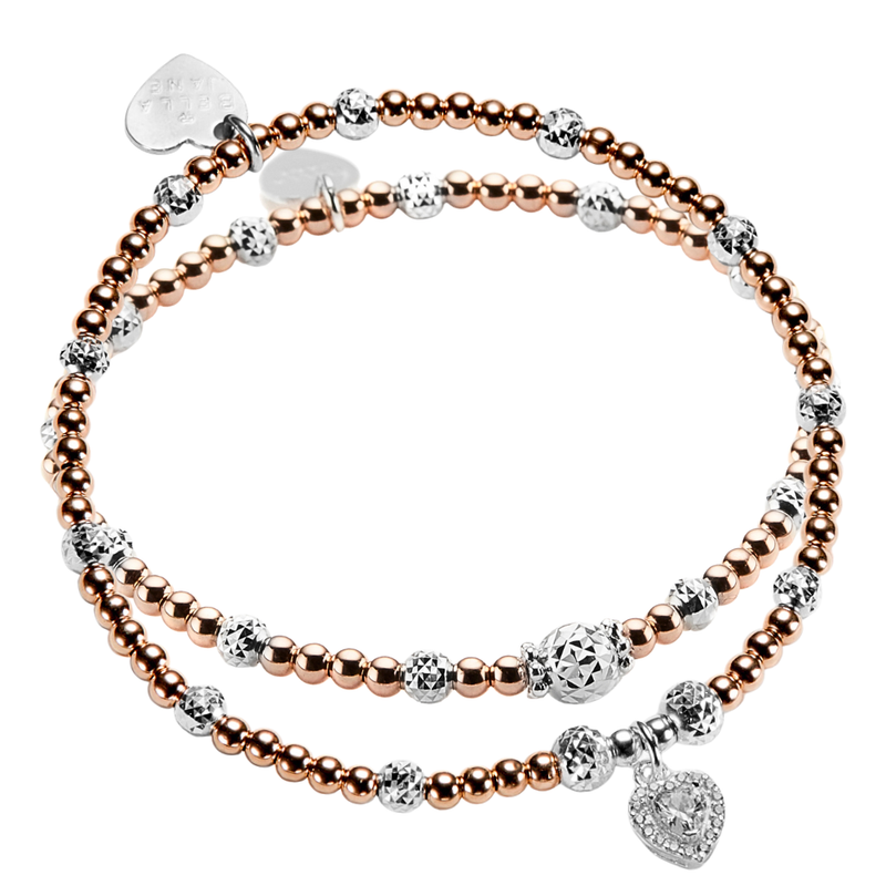 Two rose gold and silver mixed metal beaded stacking bracelets, one with a sparkly heart-shaped charm on a white background.