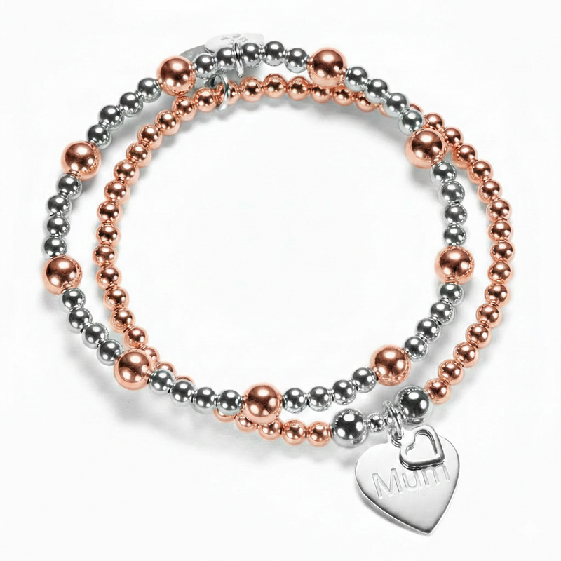 Two beaded mixed metal silver and rose gold bracelets with a heart-shaped 'Mum' charm on a white background