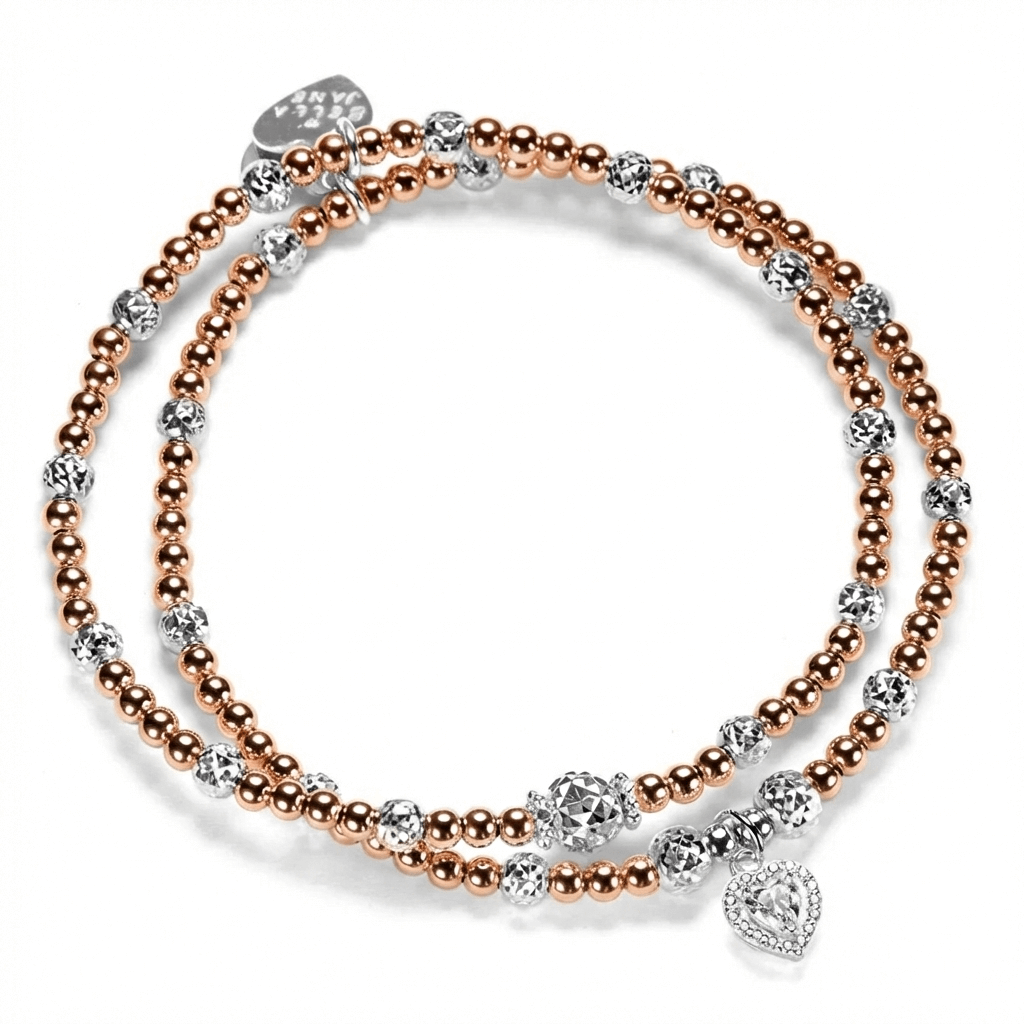 2 rose gold-filled beaded Bella Jane stacking bracelets, featuring sparkly sterling silver faceted beads, with one bracelet featuring a sterling silver and cubic zirconia sparkly heart charm, against a white background.