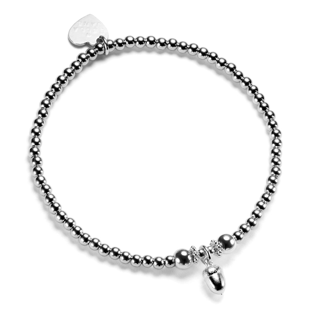 A silver beaded bracelet with a small acorn charm on a white background