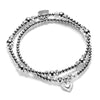 Silver beaded bracelet duo with heart charm on a white background