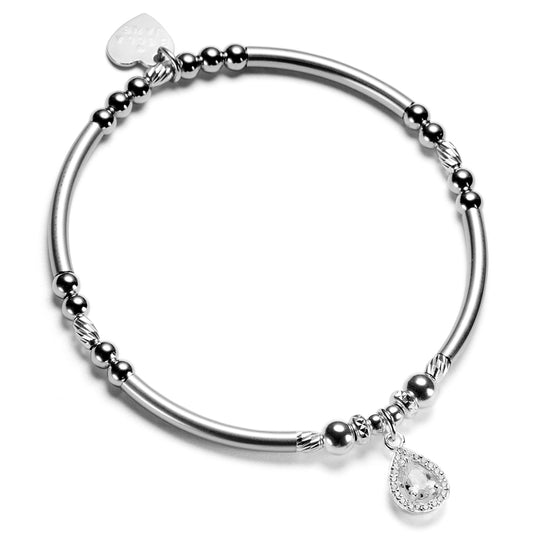 Silver beaded bracelet with a sparkly cubic zirconia tear drop shaped charm on a white background