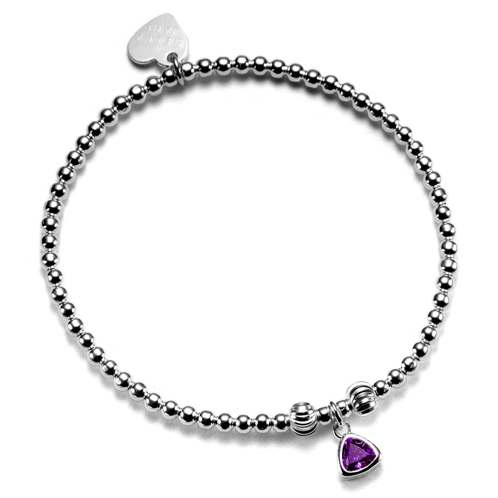 A close up of a handmade beaded bracelet featuring an amethyst coloured birthstone charm to represent February