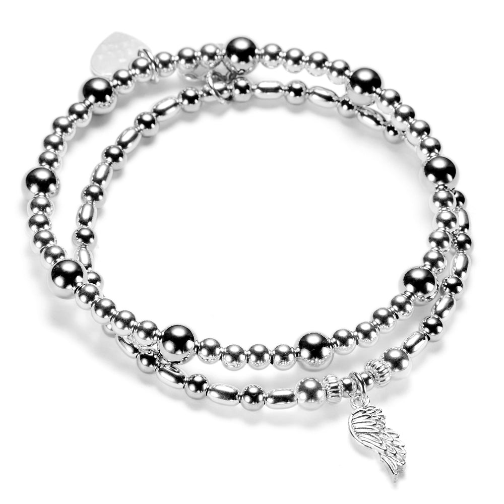 Silver beaded bracelet duo with a silver angel wing charm on a white background