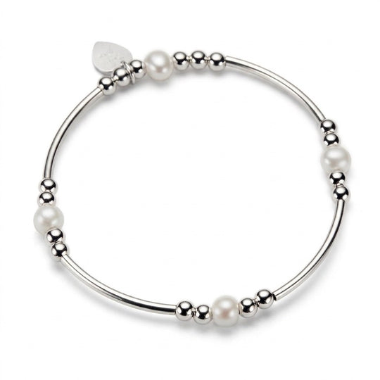 A silver beaded bracelet with cream freshwater pearl beads, shown on a clean white background.