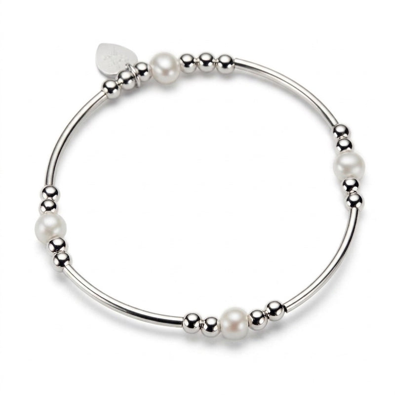 A silver beaded bracelet with cream freshwater pearl beads, shown on a clean white background.
