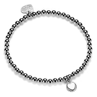 A sterling silver ball bead bracelet with a single engraved disc charm displaying a initial, presented on a white background.