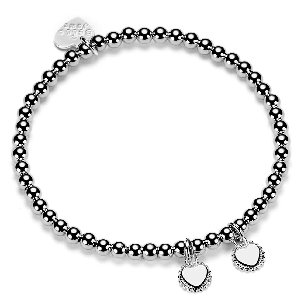 A sterling silver ball bead bracelet with two disc charms engraved with initials, presented against a white background.
