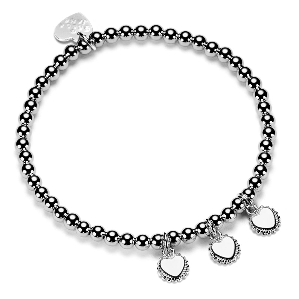 A sterling silver ball bead bracelet with three engraved sterling silver disc charms, displayed against a white background.