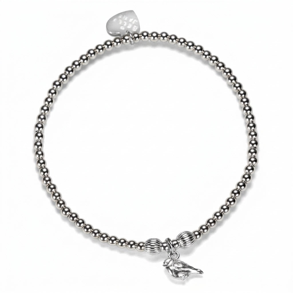 A silver beaded stretch bracelet featuring a small robin charm, displayed on a clean white background.